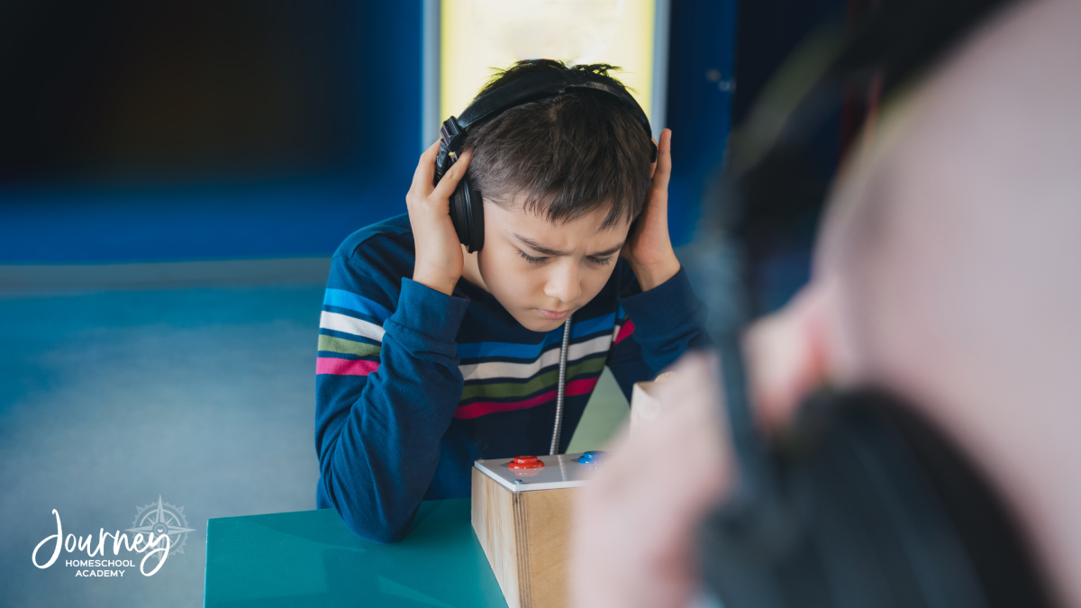 Homeschool student wearing headphones during a sound science experiment – Journey Homeschool Academy