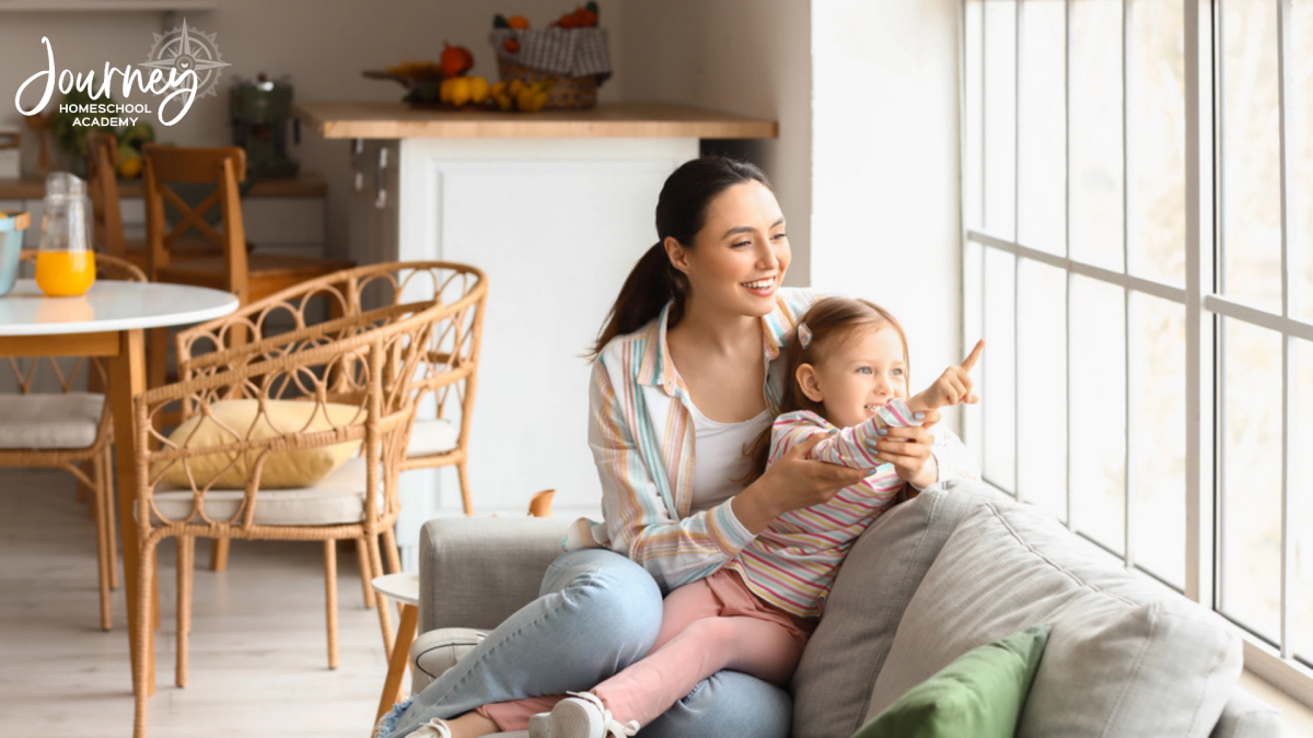 Mother and child looking out a window at birds, illustrating simple observation techniques for backyard birding homeschool ideas by region.